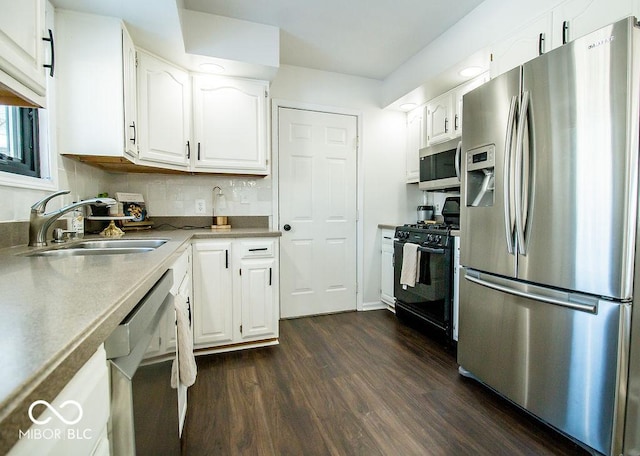 kitchen with stainless steel appliances, sink, white cabinetry, backsplash, and dark hardwood / wood-style floors