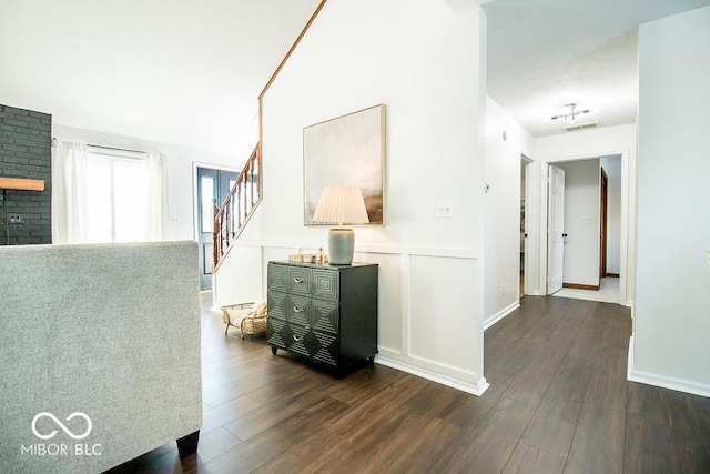 hallway with dark hardwood / wood-style flooring