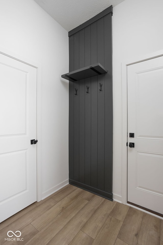 mudroom with light hardwood / wood-style floors