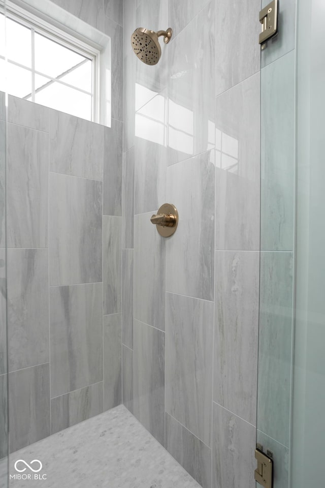 bathroom with a tile shower