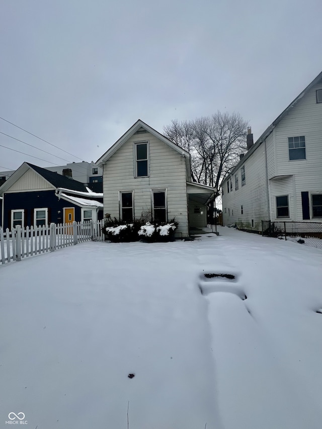 view of snow covered rear of property