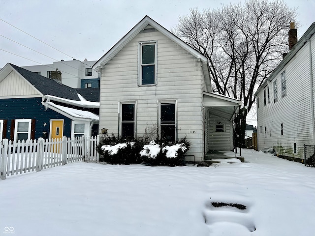 view of snow covered back of property