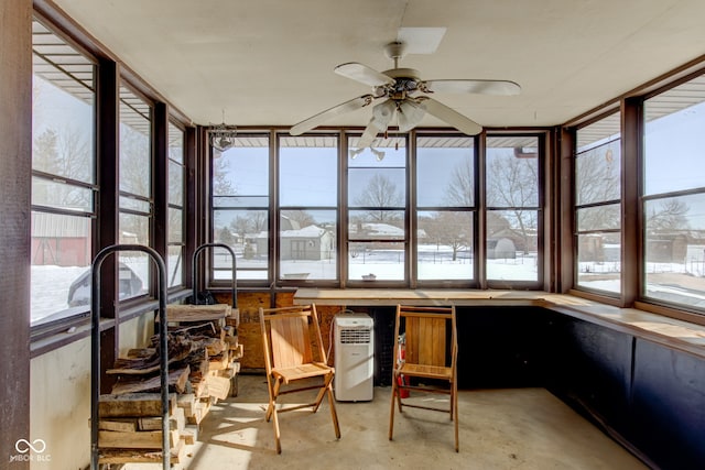 sunroom with ceiling fan and a healthy amount of sunlight