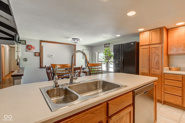 kitchen with sink, stainless steel dishwasher, and black fridge with ice dispenser