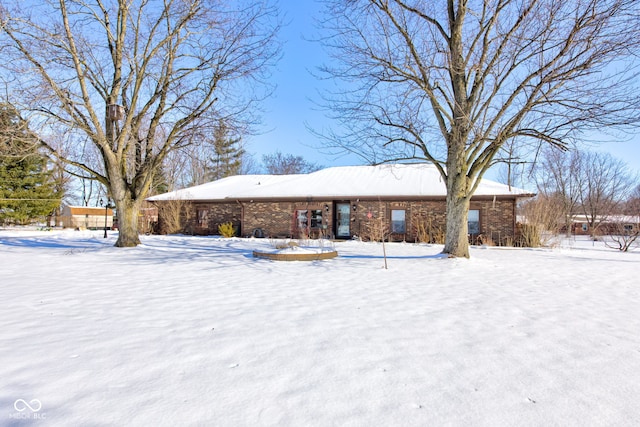 view of snow covered back of property