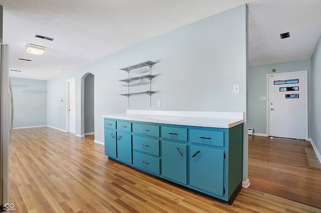 kitchen featuring light hardwood / wood-style flooring and a textured ceiling