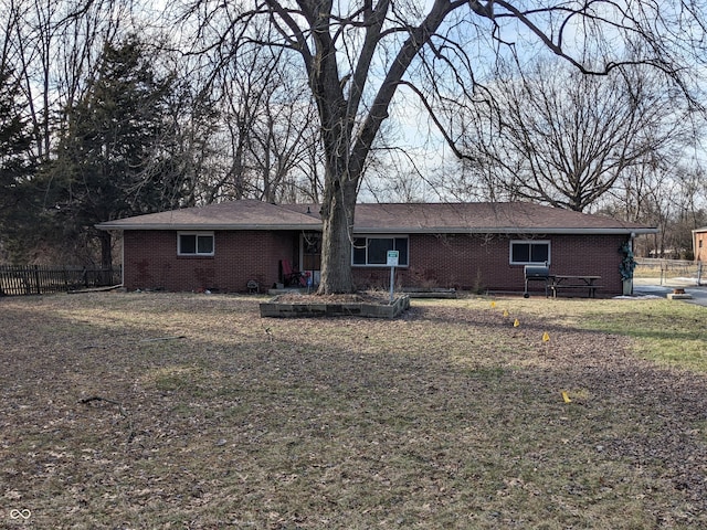 rear view of house featuring a lawn