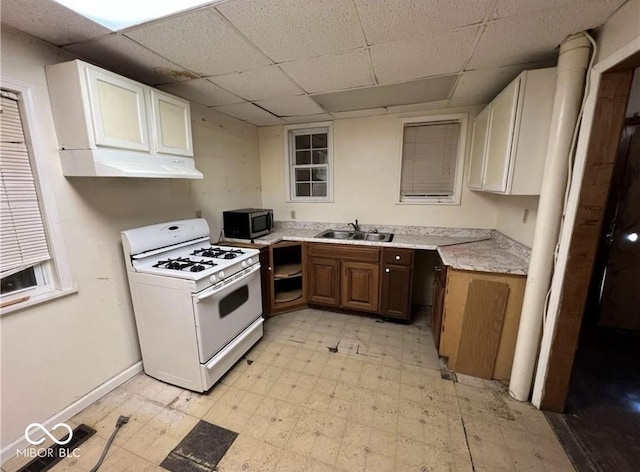 kitchen with white cabinetry, white range with gas cooktop, a paneled ceiling, and sink