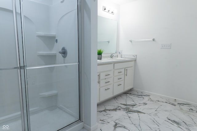 bathroom with vanity and a shower with shower door