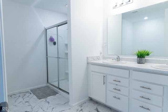 bathroom with vanity and a shower with shower door