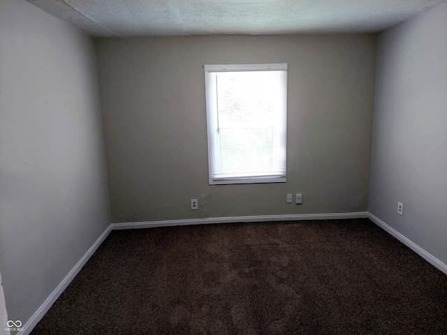 carpeted spare room featuring a textured ceiling