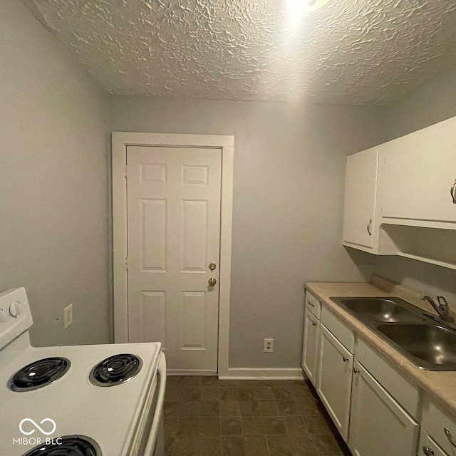 kitchen with sink, white electric range, white cabinets, and a textured ceiling