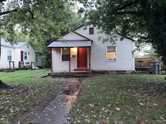 bungalow-style home with a front yard