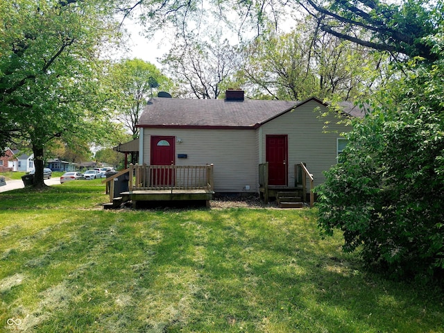 back of property with a lawn