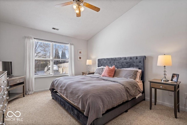 carpeted bedroom featuring ceiling fan, a textured ceiling, and lofted ceiling