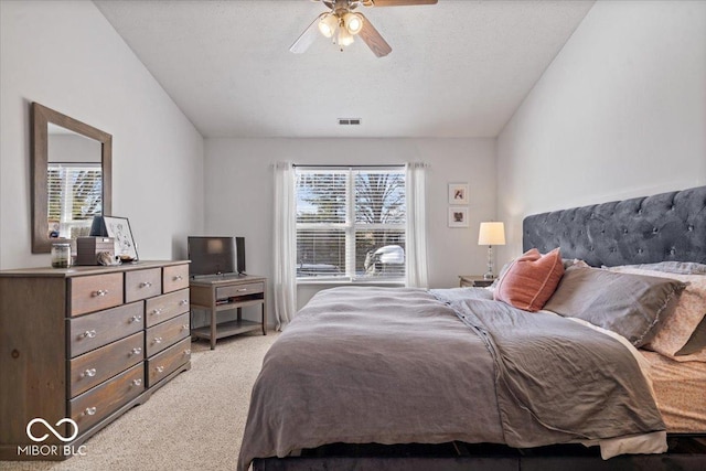 carpeted bedroom with ceiling fan, multiple windows, and a textured ceiling