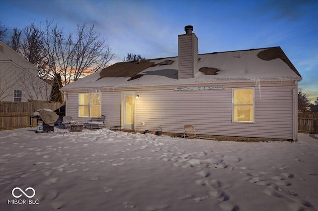 view of back house at dusk