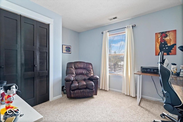 office with carpet floors and a textured ceiling