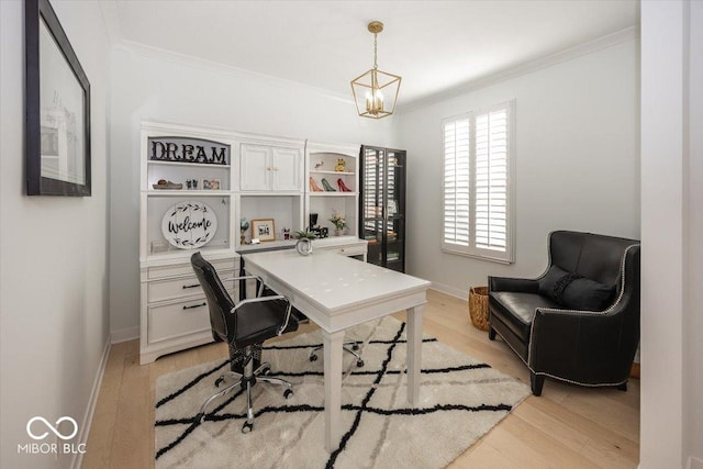 office area with light hardwood / wood-style floors, crown molding, and an inviting chandelier