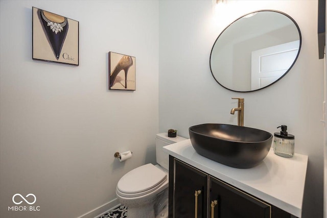 bathroom with toilet and vanity