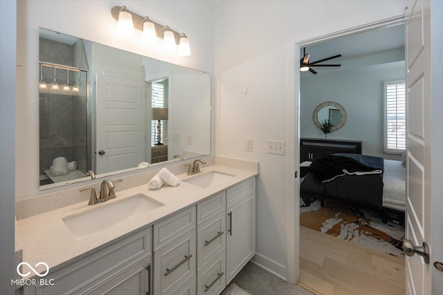 bathroom featuring ceiling fan, vanity, and a shower with door