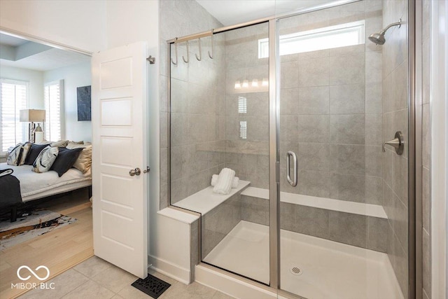 bathroom featuring a shower with shower door and tile patterned floors