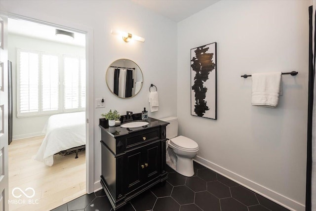 bathroom with toilet, a healthy amount of sunlight, and tile patterned flooring