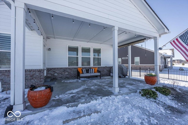 snow covered patio featuring area for grilling