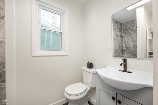 bathroom featuring toilet and vanity