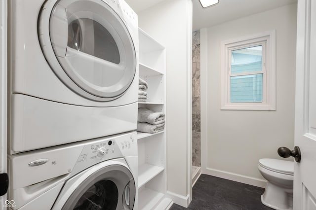 washroom featuring stacked washing maching and dryer