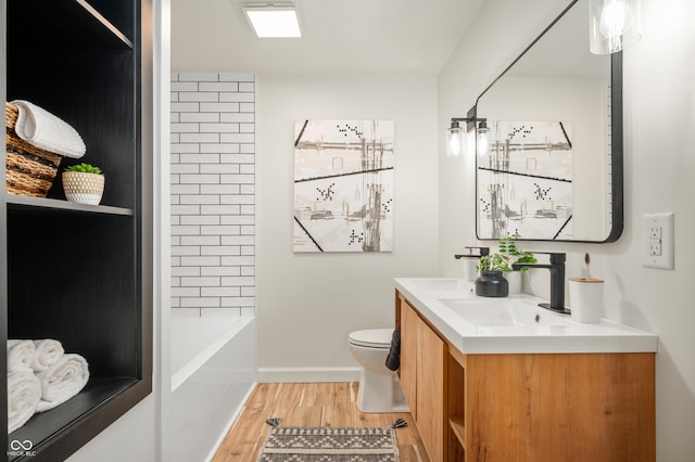 bathroom featuring toilet, vanity, and hardwood / wood-style flooring