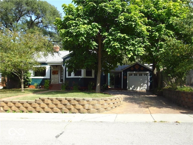 view of front of property with a garage and an outbuilding