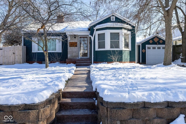 view of front of home with a garage and an outdoor structure