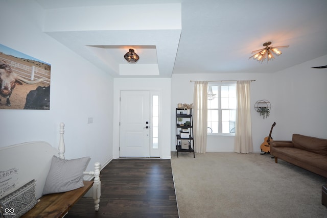 entryway with dark hardwood / wood-style flooring and an inviting chandelier