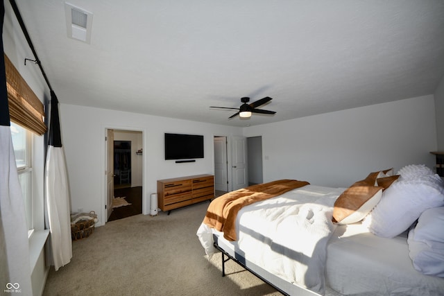 bedroom with ceiling fan and light colored carpet