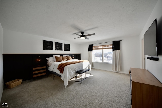 bedroom featuring carpet flooring, a textured ceiling, and ceiling fan