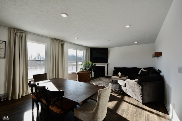 dining area featuring dark hardwood / wood-style flooring and a textured ceiling