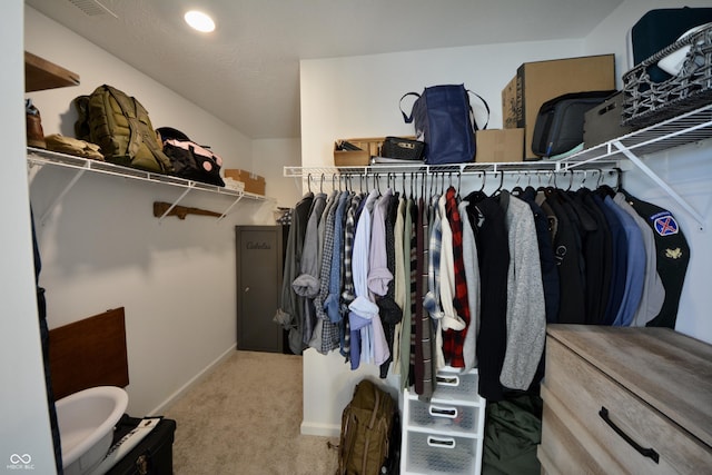 walk in closet featuring carpet flooring