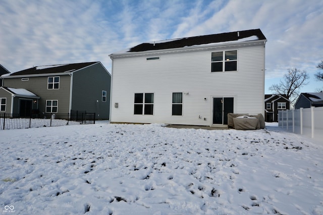 view of snow covered rear of property