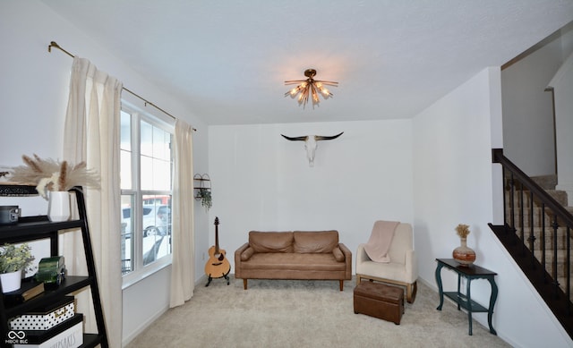 living area with an inviting chandelier and light carpet