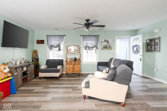 living room with hardwood / wood-style flooring and ceiling fan