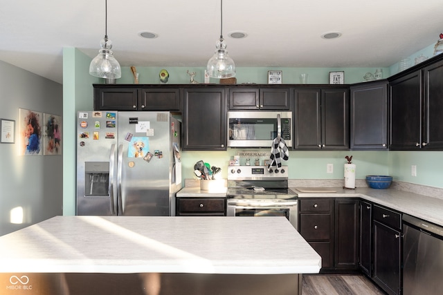 kitchen with pendant lighting, stainless steel appliances, and a kitchen island