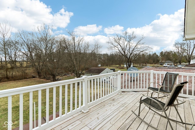 wooden terrace featuring a yard