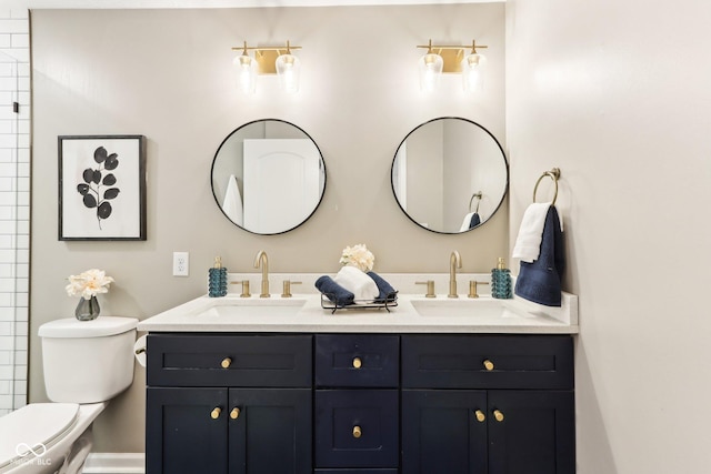 bathroom featuring vanity and toilet