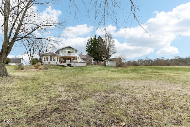 view of yard featuring a rural view and a sunroom