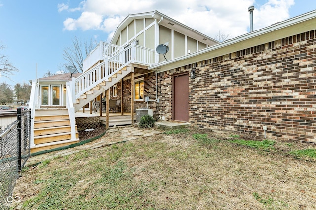 exterior space with cooling unit and a wooden deck