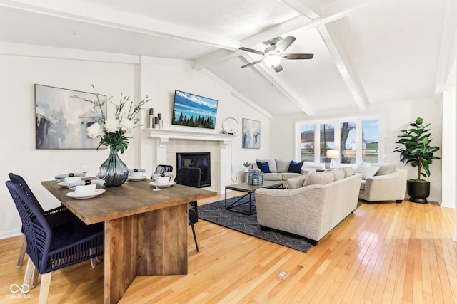 living room featuring lofted ceiling with beams, ceiling fan, a fireplace, and hardwood / wood-style floors