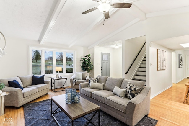 living room featuring lofted ceiling with beams, ceiling fan, and hardwood / wood-style floors