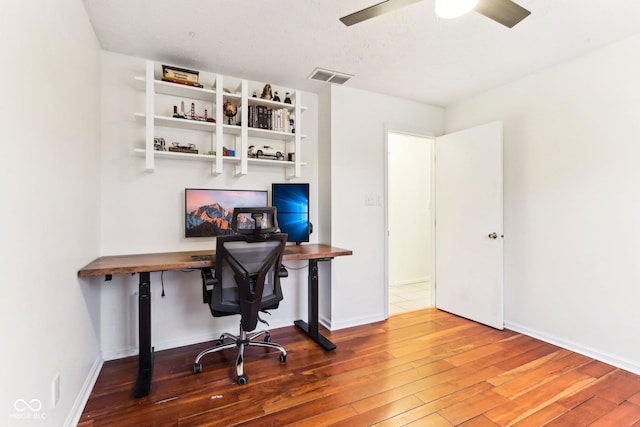 home office featuring hardwood / wood-style flooring and ceiling fan