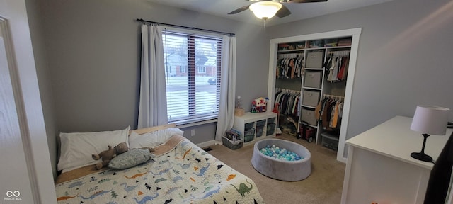 bedroom with a closet, ceiling fan, and carpet floors